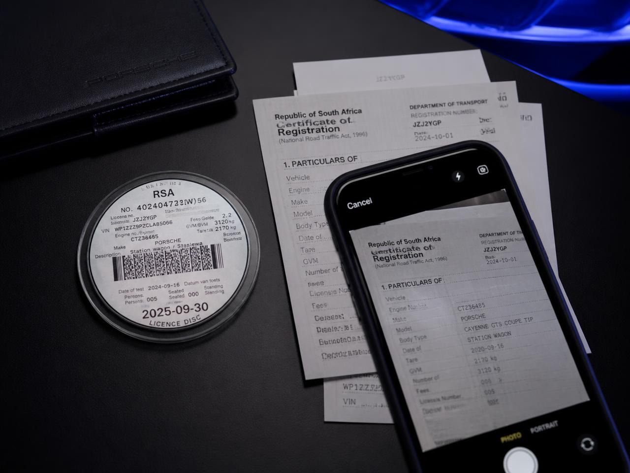 Official government forms on a desk beside a phone